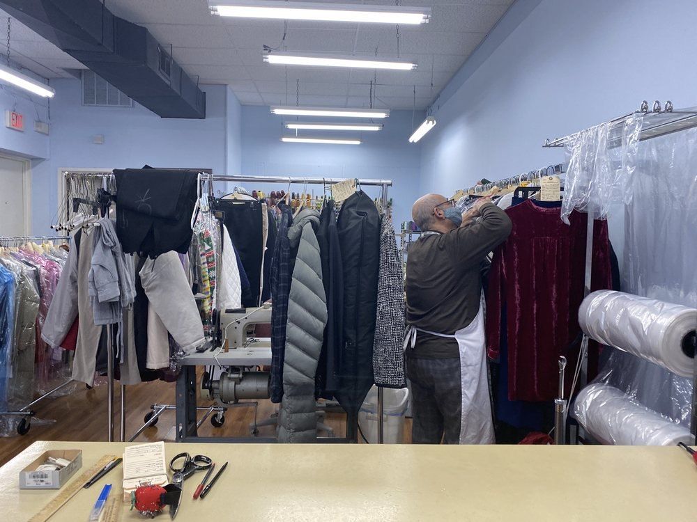 Racks of garments and the cutting table inside the shop